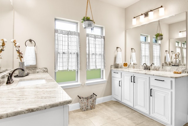 bathroom featuring tile patterned floors, vanity, and baseboards