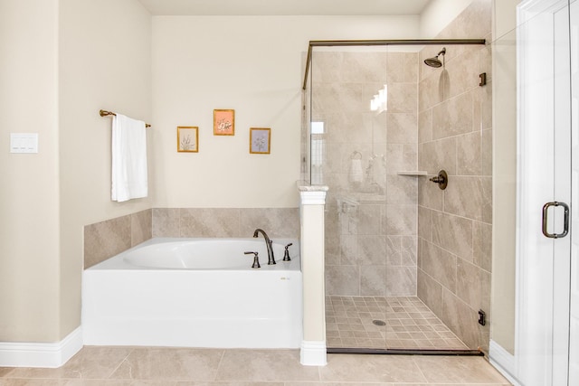 full bathroom with a stall shower, a garden tub, and tile patterned floors