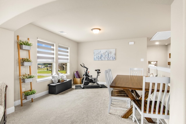 exercise room with arched walkways, carpet floors, visible vents, baseboards, and attic access