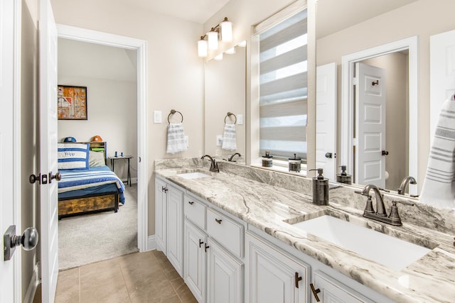 bathroom with tile patterned floors, a sink, ensuite bath, and double vanity