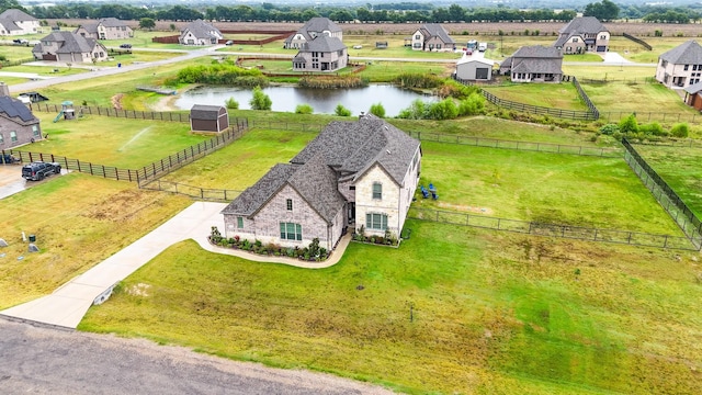 bird's eye view featuring a water view, a residential view, and a rural view