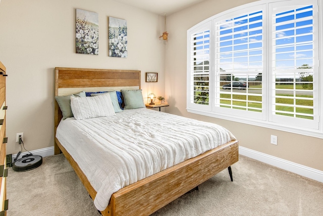 bedroom featuring carpet floors and baseboards