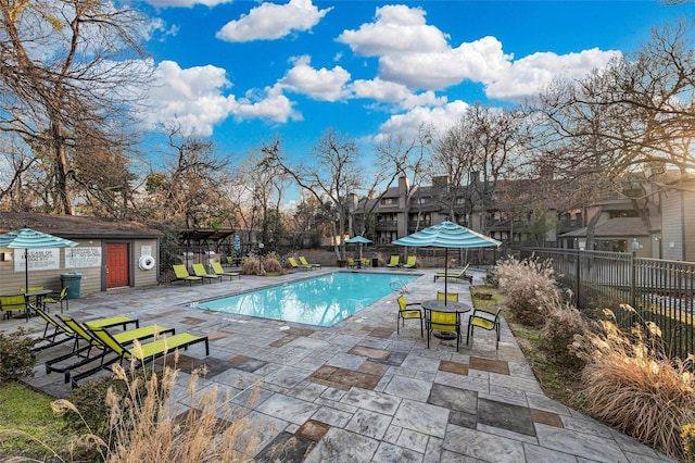 community pool featuring a patio area and fence