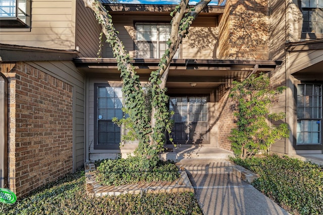 entrance to property with brick siding