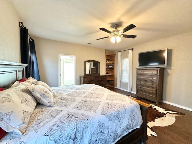 bedroom with visible vents, ceiling fan, a textured ceiling, and baseboards