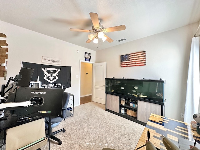 office featuring ceiling fan, a textured ceiling, visible vents, and baseboards