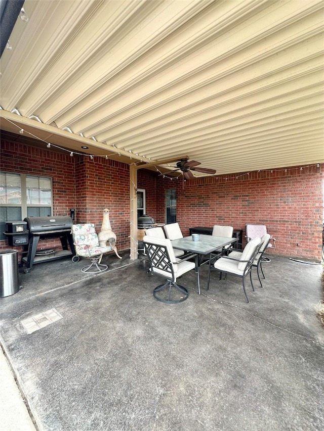 view of patio featuring ceiling fan, outdoor dining space, and grilling area