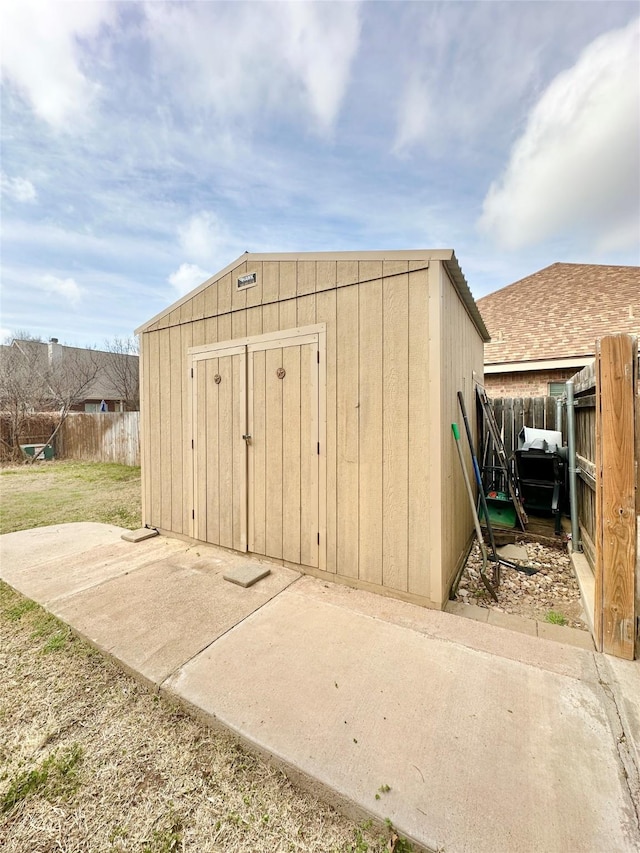 view of shed with a fenced backyard