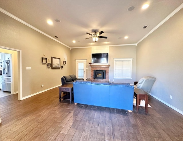 living area featuring dark wood-style flooring, a fireplace, visible vents, and baseboards