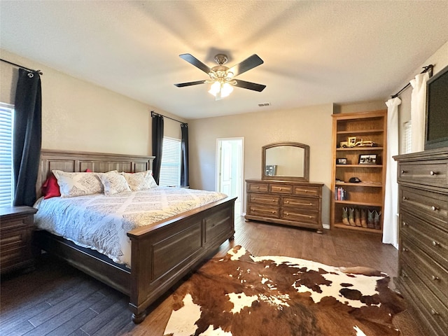 bedroom with multiple windows, visible vents, and wood finished floors