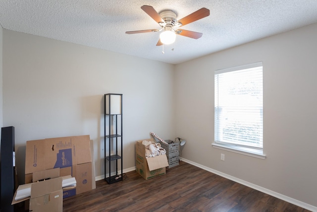 miscellaneous room with a ceiling fan, a textured ceiling, baseboards, and wood finished floors