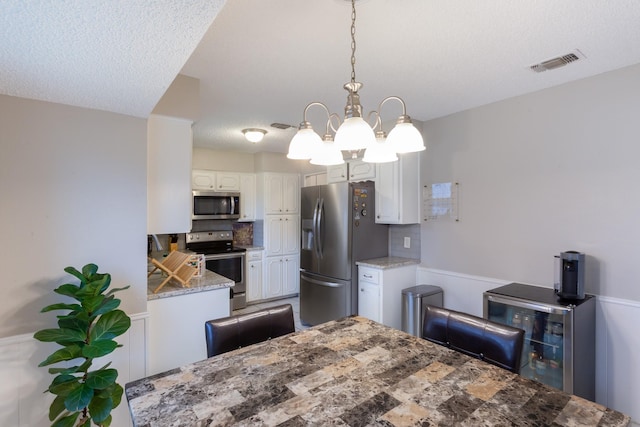 dining space with visible vents and a textured ceiling