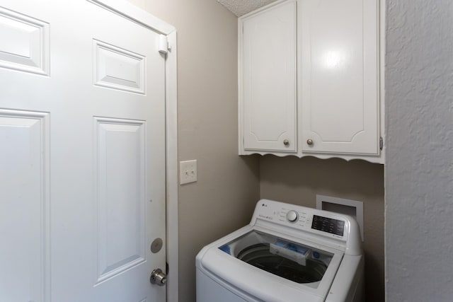 washroom featuring cabinet space and washer / dryer