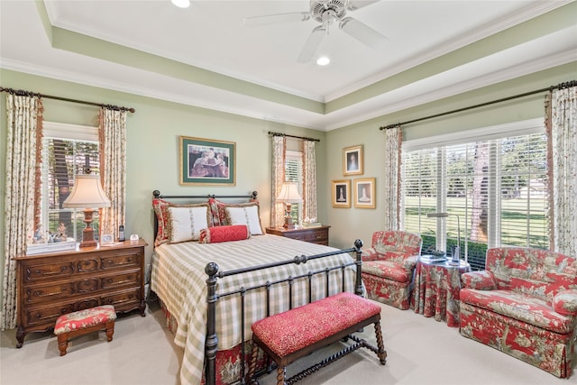 bedroom with carpet, a raised ceiling, crown molding, and ceiling fan