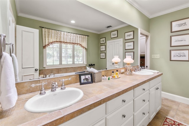 bathroom featuring ornamental molding, a sink, baseboards, and double vanity