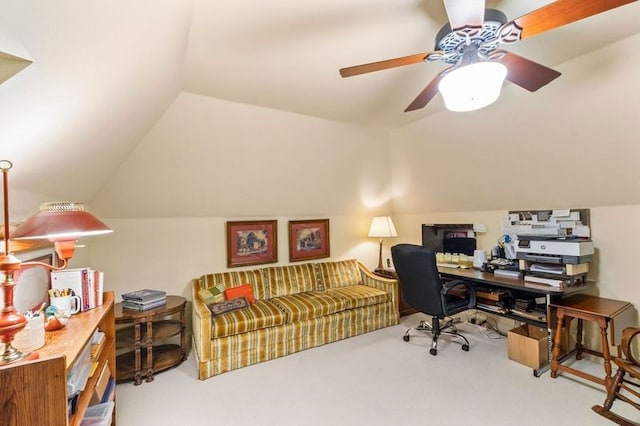 carpeted home office featuring lofted ceiling and a ceiling fan