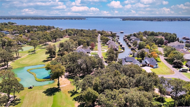 birds eye view of property with golf course view, a water view, and a residential view