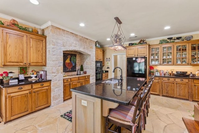 kitchen featuring brown cabinetry, crown molding, a sink, and black appliances