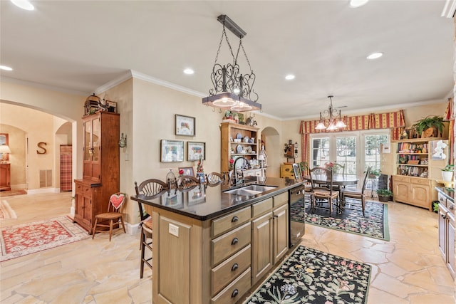 kitchen featuring arched walkways, a kitchen island with sink, a sink, and dishwasher