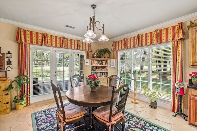 dining space featuring plenty of natural light, visible vents, stone tile flooring, and ornamental molding