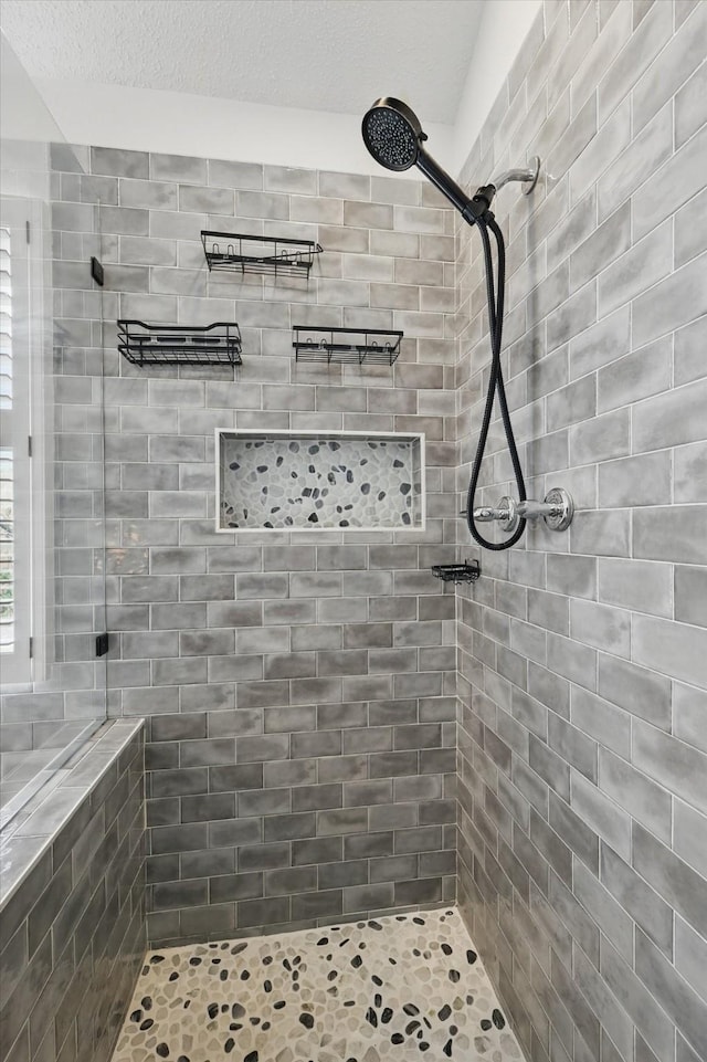 bathroom with a tile shower