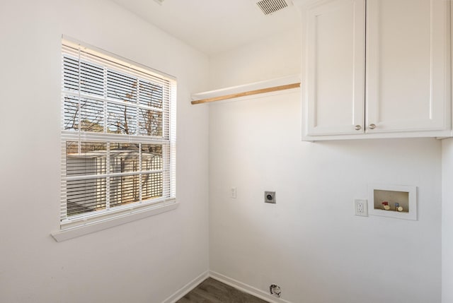 clothes washing area with hookup for a washing machine, hookup for an electric dryer, visible vents, baseboards, and cabinet space