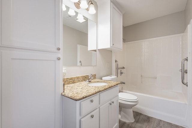 full bath featuring bathing tub / shower combination, vanity, toilet, and wood finished floors