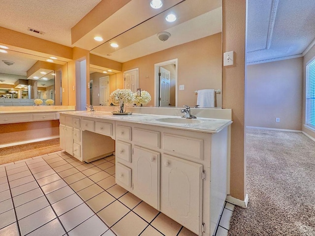 full bathroom featuring a sink, a textured ceiling, baseboards, and double vanity