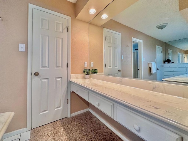 bathroom with vanity and baseboards