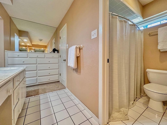 bathroom featuring curtained shower, vanity, toilet, and tile patterned floors