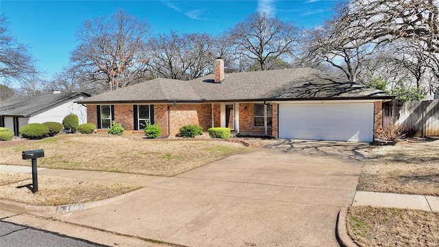 single story home featuring driveway, a chimney, an attached garage, fence, and brick siding