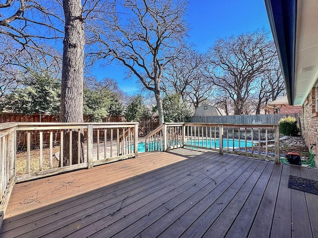 deck featuring a fenced backyard and an outdoor pool