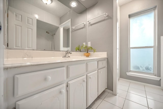 1803 Burr Oak St, Arlington, TX 76012 - full bath with a textured ceiling, tile patterned flooring, vanity, and a shower