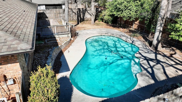 view of swimming pool with a fenced backyard