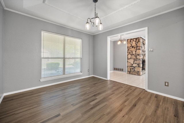 1803 Burr Oak St, Arlington, TX 76012 - spare room featuring a chandelier, wood finished floors, crown molding, baseboards, and a raised ceiling