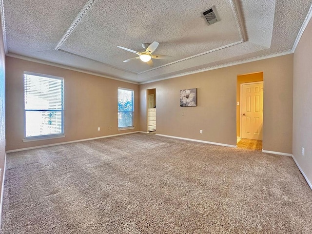 carpeted empty room featuring baseboards, plenty of natural light, visible vents, and crown molding