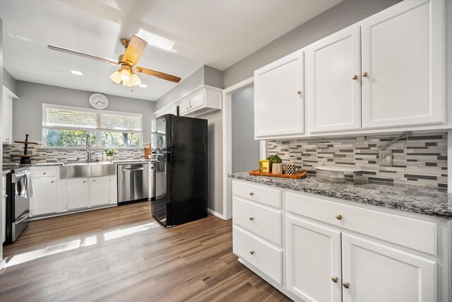 1803 Burr Oak St, Arlington, TX 76012 - kitchen featuring freestanding refrigerator, a sink, dishwasher, electric range, and white cabinetry