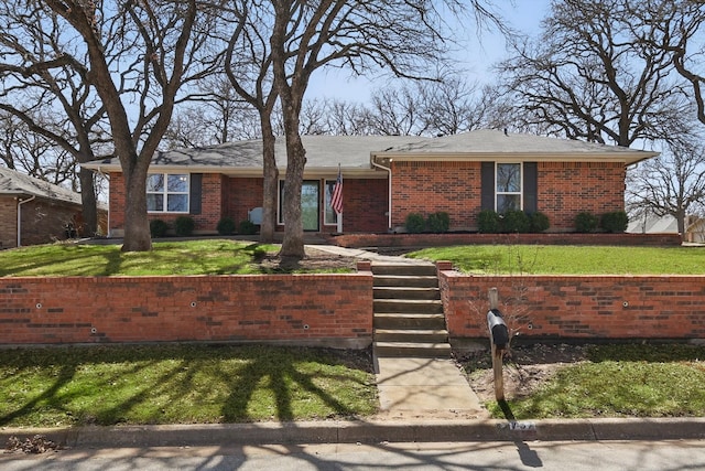 single story home featuring a front lawn and brick siding