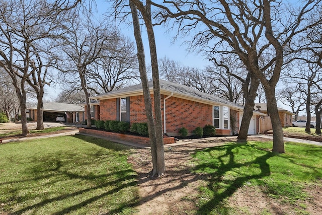 view of property exterior featuring a garage, brick siding, a yard, and driveway