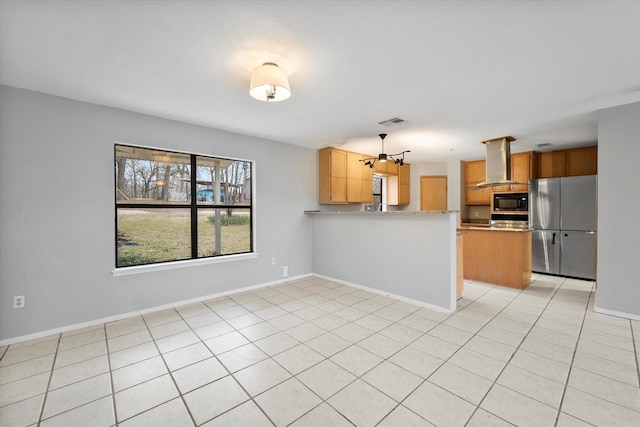 kitchen featuring black microwave, light tile patterned flooring, visible vents, freestanding refrigerator, and island exhaust hood