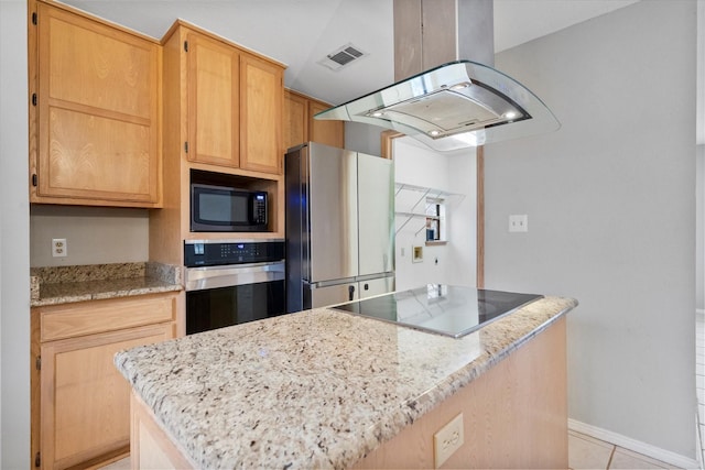 kitchen featuring baseboards, visible vents, a center island, island exhaust hood, and black appliances