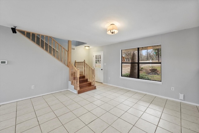 spare room featuring visible vents, stairs, and baseboards