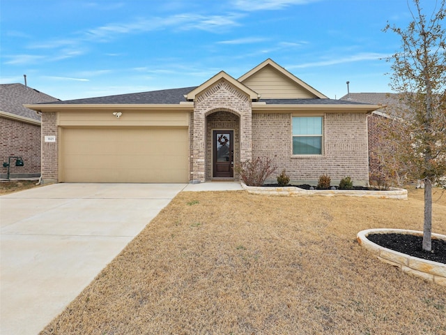 single story home with concrete driveway, brick siding, an attached garage, and a shingled roof