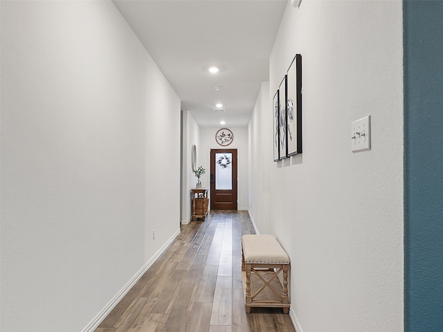 hallway with recessed lighting, wood finished floors, and baseboards