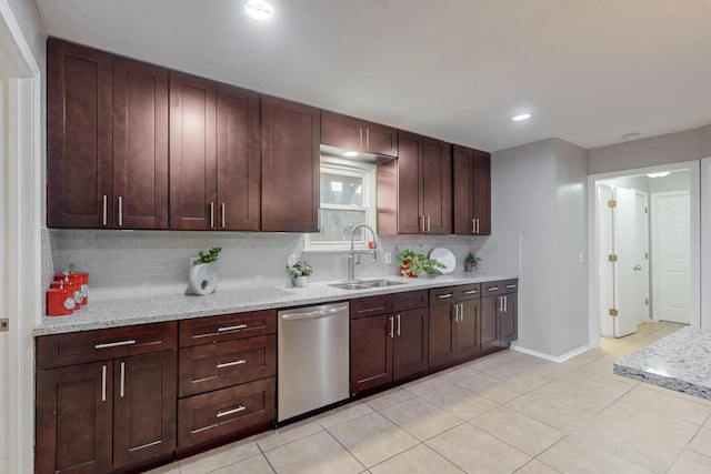 kitchen with light stone counters, light tile patterned floors, backsplash, a sink, and dishwasher