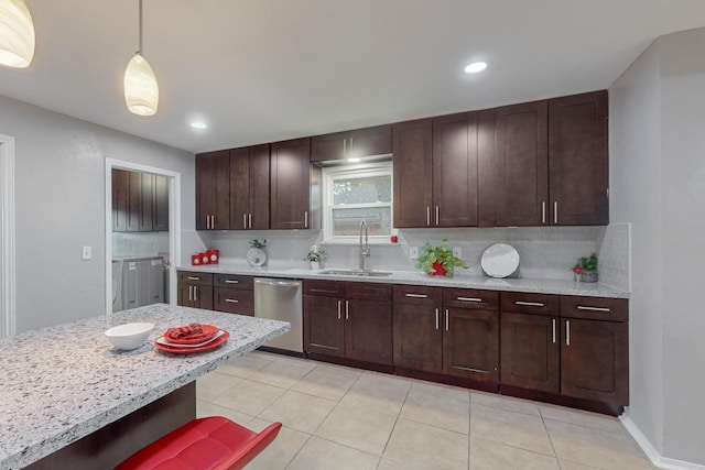 kitchen with light tile patterned floors, tasteful backsplash, dishwasher, pendant lighting, and a sink