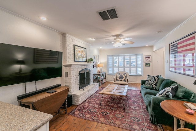 living area featuring brick floor, a fireplace, visible vents, a ceiling fan, and ornamental molding