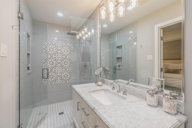 bathroom featuring recessed lighting, a chandelier, walk in shower, and vanity