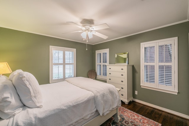 bedroom featuring ceiling fan, baseboards, dark wood finished floors, and crown molding