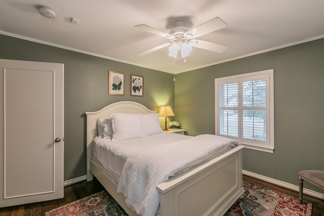 bedroom with baseboards, ceiling fan, dark wood finished floors, and crown molding